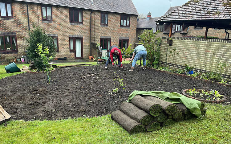 photo of trident's director laying a new communal garden for local elderly residents
